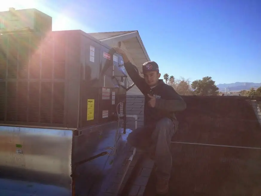 HVAC technician performing HVAC Inspection on a rooftop unit in Pelican Bay